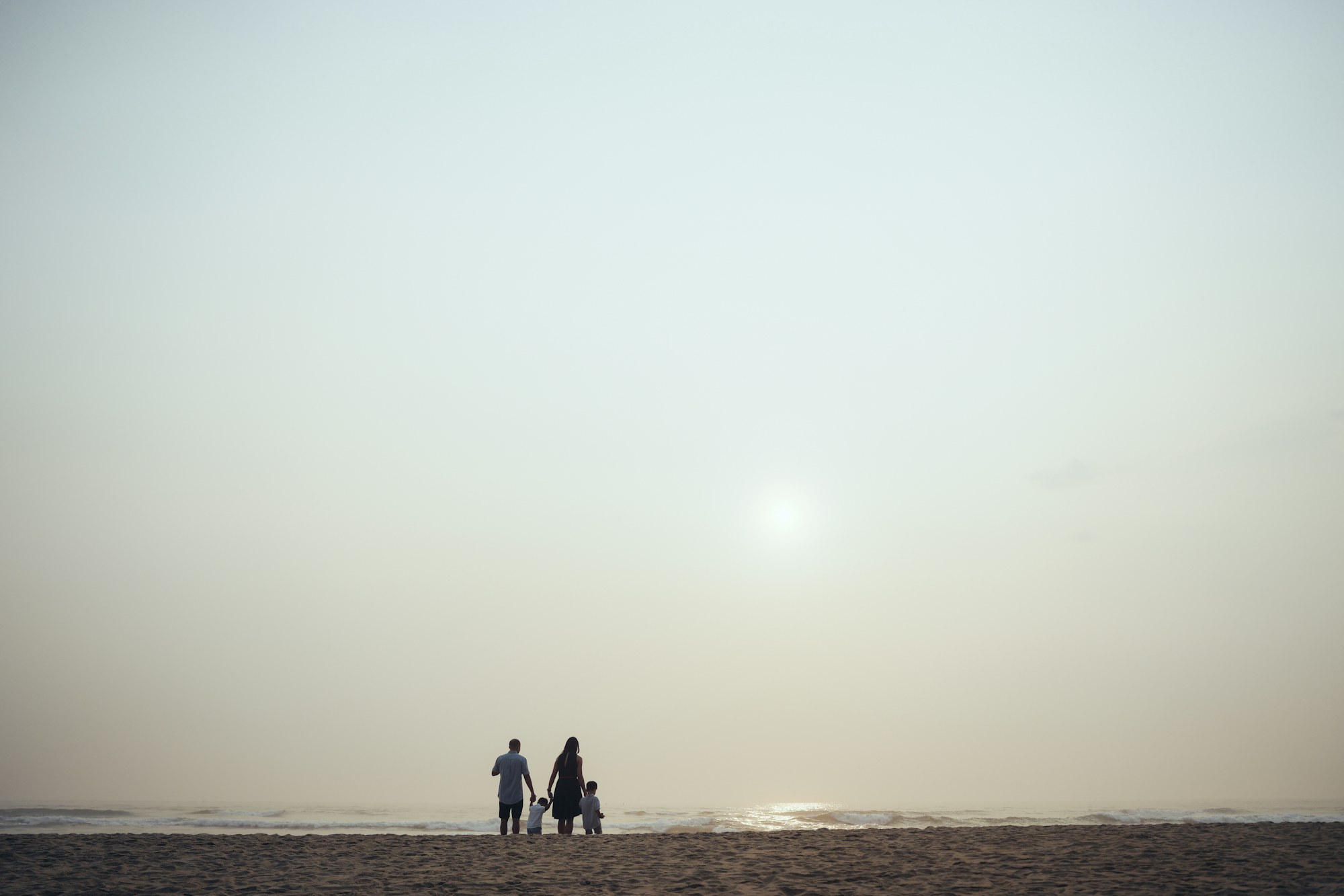 Family standing together at the shoreline